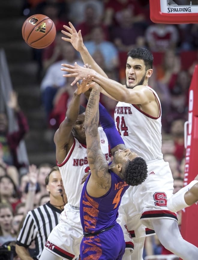 NC State's defense, which forced 17 turnovers, swarm Clemson guard Shelton Mitchell.