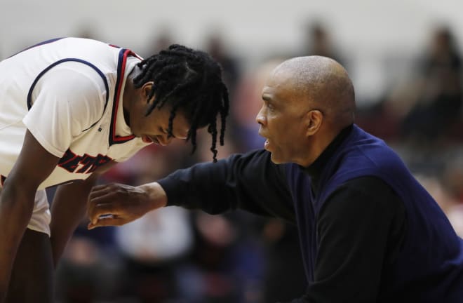 Detroit Mercy coach Mike Davis talks to his son, Antoine Davis, who is sophomore guard for the Titans.