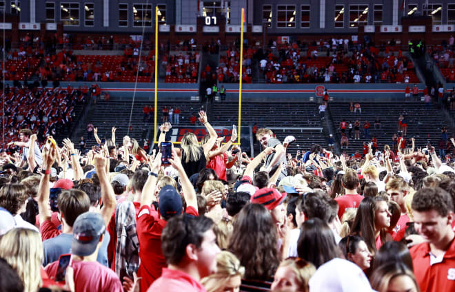 N.C. State fans rush the field at Carter-Finley Stadium Saturday evening after the Wolfpack defeated No. 9 Clemson 27-21 in double overtime, snapping an 8-game losing streak.