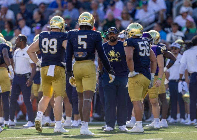 Notre Dame's defensive linemen gather around Irish D-line coach Al Washington during ND's 28-3 win Saturday over Miami (Ohio).