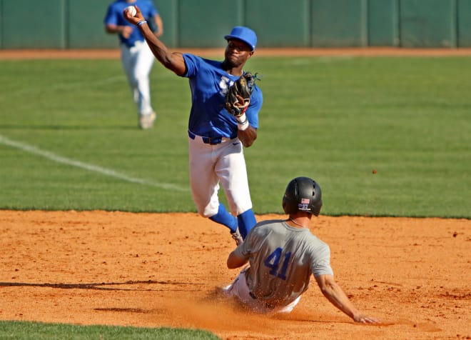Junior second baseman Zeke Lewis turns two as Grant Macciocchi attempts to break up the play with a slide.