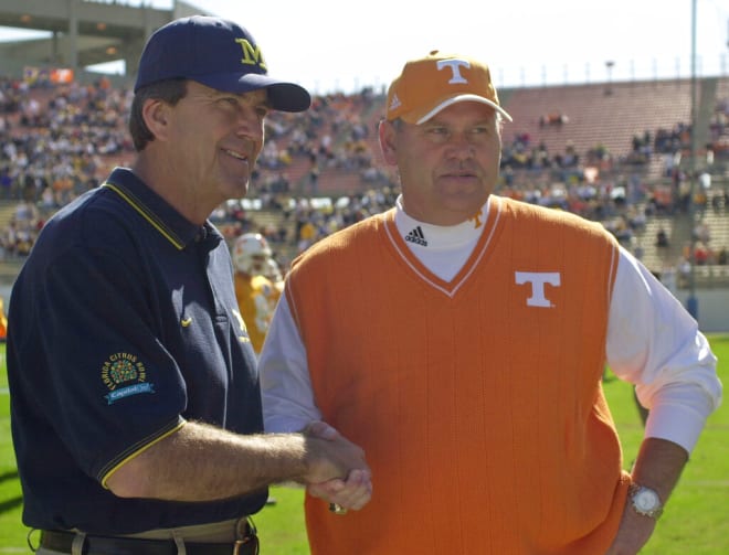 Michigan head coach Lloyd Carr, left, and Tennessee head coach Phillip Fulmer shake hands Tuesday, Jan. 1, 2002, prior to the start of the 56th Annual Capital One Florida Citrus Bowl in Orlando, Fla.