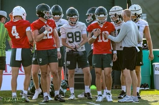 Michigan State quarterbacks talk to offensive coordinator/quarterbacks coach Jay Johnson 