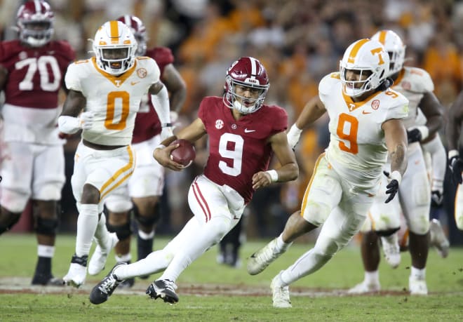 Alabama Crimson Tide quarterback Bryce Young (9) scrambles for a first down against Tennessee Volunteers defensive lineman Tyler Baron (9) at Bryant-Denny Stadium. Alabama won 52-24. Photo | USA TODAY