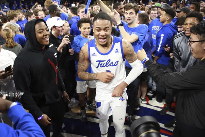 Elijah Joiner is surrounded by Tulsa fans after his game-winning shot against Wichita State.