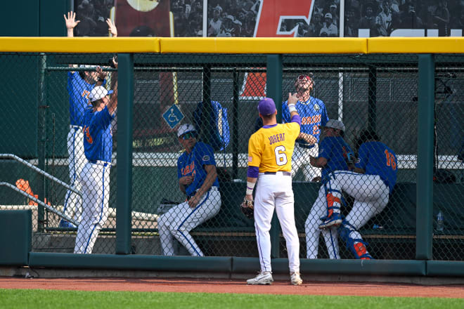 This was a familiar sight -- an LSU outfielder watching the last of Florida's six home runs clear the fence -- in the Gators' 24-4 spanking of the Tigers' in game 2 of the College World Series finals Sunday afternoon in Omaha. The teams meet in Monday night's winner-take-all game 3 at 6 p.m.