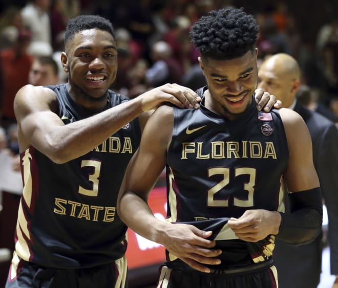 FSU freshman M.J. Walker (No. 23) celebrates with teammate Trent Forrest after his 24-point performance Saturday.