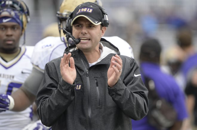 Former James Madison defensive coordiantor Brandon Staley encourages the Dukes during a 2014 contest against Towson at Bridgeforth Stadium. 