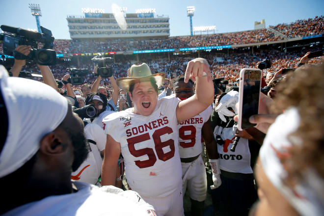 Former OU center Creed Humphrey give the 'horns down' signal. 