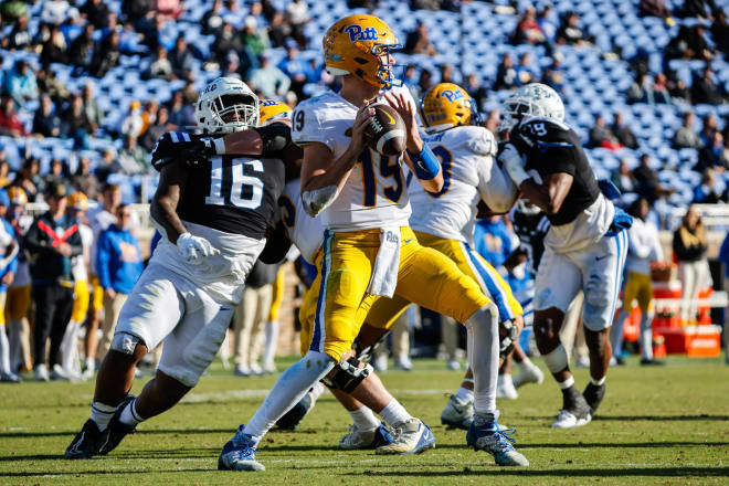 Duke defensive tackle Aeneas Peebles, left, rushes Pitt quarterback Nate Yarnell. 
