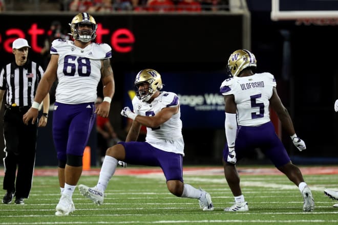 Junior edge rusher Bralen Trice (No. 8) and senior linebacker Edefuan Ulofoshio (No. 5) celebrate a player earlier this season.