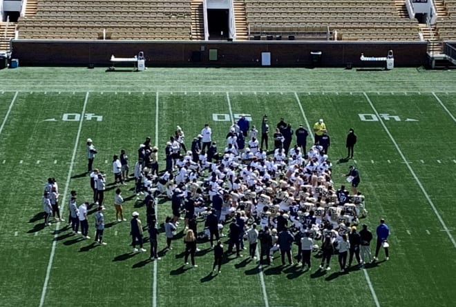 Coach Collins huddles his team up after practice