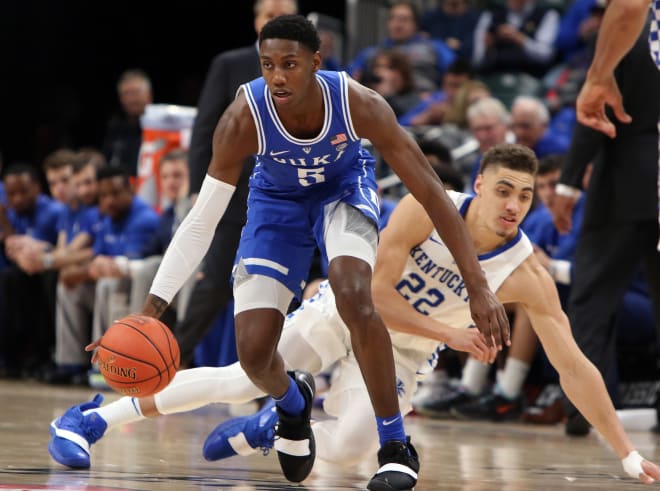 Duke's R.J. Barrett picked up a loose ball before a diving Reid Travis of Kentucky could scoop it up in Tuesday's Champions Classic game. Barrett scored a game-high 33 points in the Blue Devils' 118-84 win.