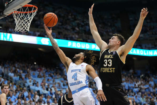 UNC's RJ Davis makes a layup in front of Wake Forest's Matthew Marsh during Wednesday night's game. 