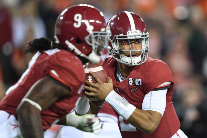 Alabama Crimson Tide quarterback Jalen Hurts (2) looks to pass as running back Bo Scarbrough (9) runs during the third quarter against the Clemson Tigers in the 2017 College Football Playoff National Championship Game at Raymond James Stadium. 