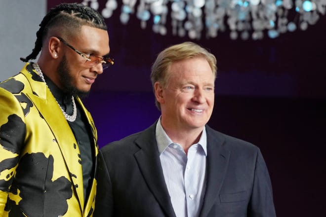 FSU defensive end Jermaine Johnson poses for a photo at the Draft on Thursday with NFL Commissioner Roger Goodell.