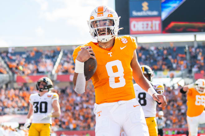 Jan 1, 2024; Orlando, FL, USA; Tennessee Volunteers quarterback Nico Iamaleava (8) runs for the touchdown against the Iowa Hawkeyes in the second quarter at Camping World Stadium.