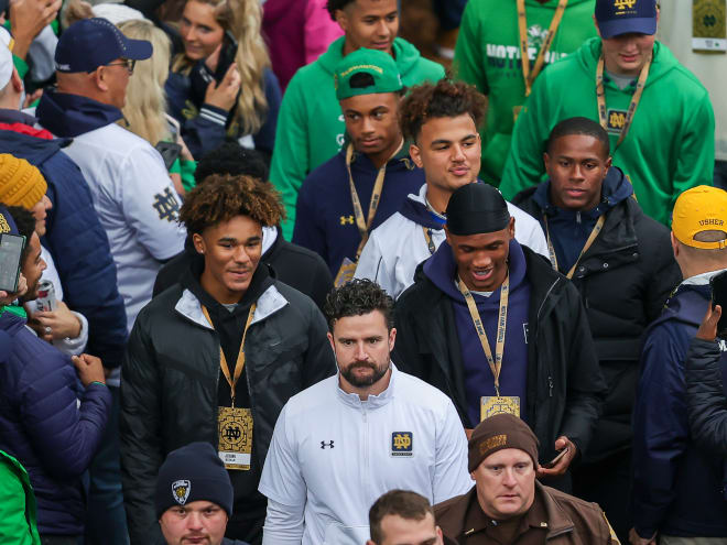 Notre Dame director of recruiting Chad Bowden, front in white, plans to stay with the Irish.