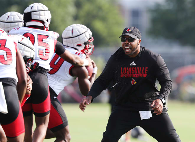 U of L running backs coach De'Rail Sims conducts drills during practice on fan day outside Cardinal Stadium in Louisville, Ky. on Aug. 8, 2021. 