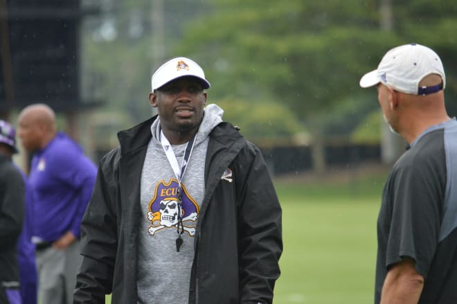 Scottie Montgomery and offensive coordinator Tony Petersen chat during Tuesday practice.