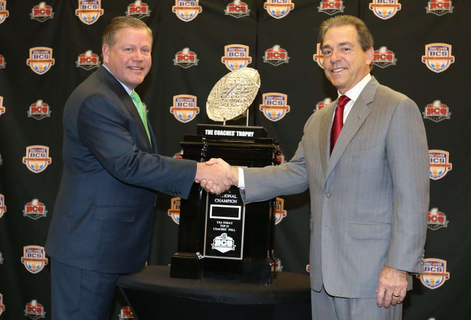 Then-Notre Dame head coach Brian Kelly shakes hands with Alabama head coach Nick Saban in a press conference before the 2013 BCS national championship game won by the Crimson Tide 42-14.