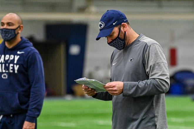 Mike Yurcich works at Penn State's spring practices. (Photo credit: Mark Selders/Penn State Athletics)