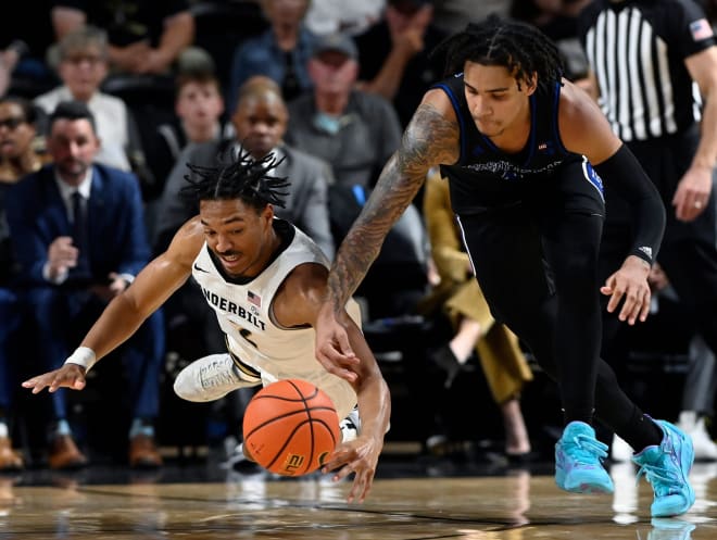 Vanderbilt's Evan Taylor, left, and Presbyterian's Marquis Barnett go after a loose ball during the season opener. Presbyterian won the game 68-62.  