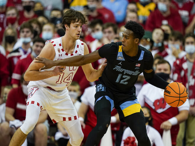 Carter Gilmore defends Marquette's Olivier-Maxence Prosper (12) in the second half of Wisconsin's 89-76 victory.