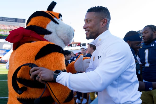 Notre Dame head football coach Marcus Freeman (right) declined to let Tony the Tiger call plays in the Sun Bowl.