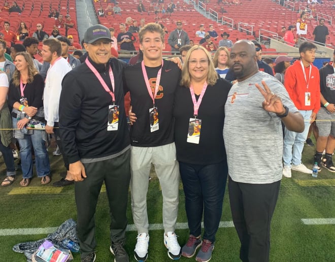 2021 DB prospect Hunter Barth with his family and USC DBs coach Greg Burns before the Trojans' game vs. Arizona on Saturday in the Coliseum.