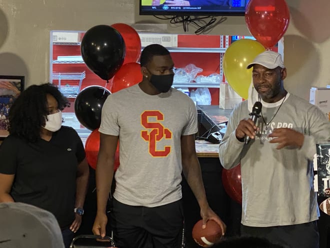 Michael Trigg, center, with his parents Tywanca and Michael Sr. at his commitment announcement party last October in Tampa, Fla.