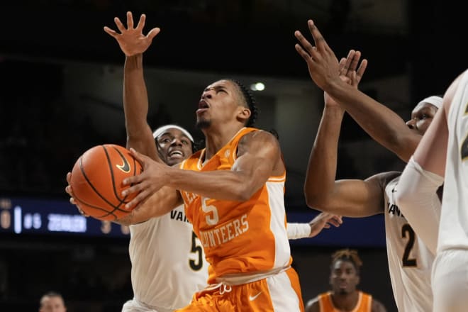 Tennessee guard Zakai Zeigler (5) drives to the basket past Vanderbilt guard Ezra Manjon (5) and forward Ven-Allen Lubin (2) during the first half of an NCAA college basketball game Saturday, Jan. 27, 2024, in Nashville, Tenn. (AP Photo/George Walker IV)