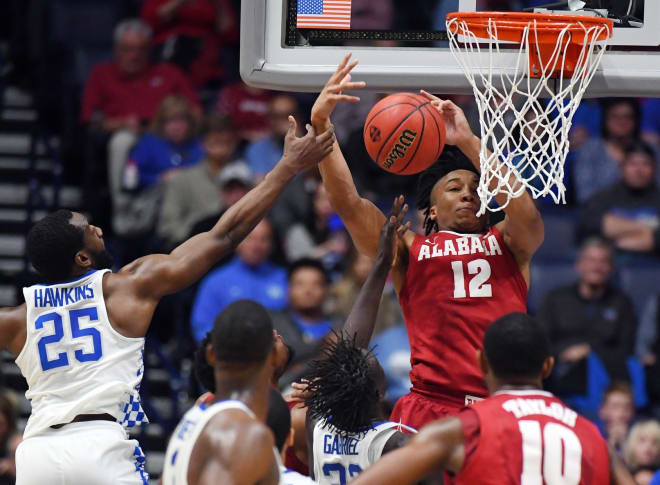 Alabama Crimson Tide guard Dazon Ingram (12) attempts a shot with pressure from Kentucky Wildcats guard Dominique Hawkins (25) during the first half during the SEC Conference Tournament at Bridgestone Arena. Mandatory Credit: Christopher Hanewinckel-USA TODAY Sports.