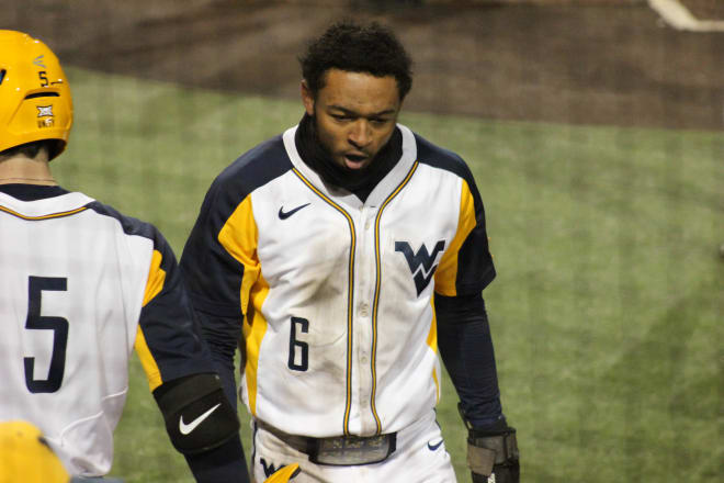 West Virginia outfielder Victor Scott comes around to score in the bottom of the eighth, tying the score at four.