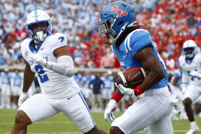 Ole Miss Rebels running back Henry Parrish Jr. (21) runs after a catch as Kentucky Wildcats quarterback Gavin Wimsatt (2) pursues during the first half at Vaught-Hemingway Stadium. Mandatory Credit: Petre Thomas-Imagn Images