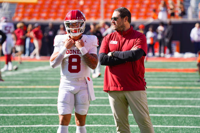 Jeff Lebby converses with Dillon Gabriel before a Nov. 4 date with Oklahoma State