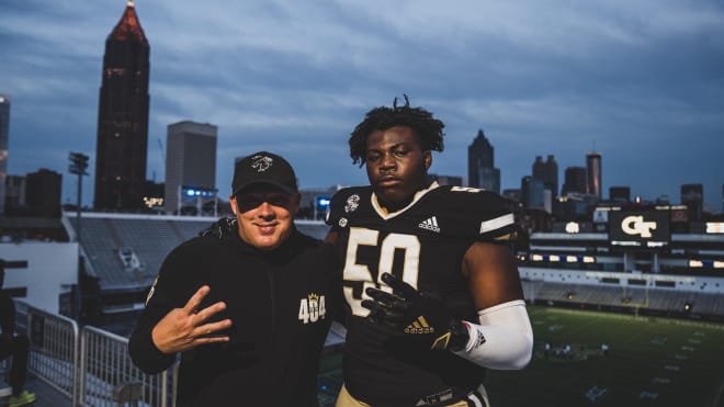 Hixon poses with Geoff Collins in the Black Watch Jersey during his official visit