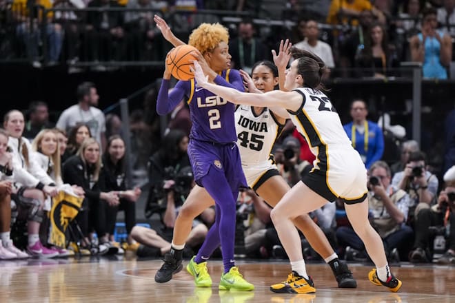 LSU Lady Tigers guard Jasmine Carson (2) controls the ball against Iowa Hawkeyes forward Hannah Stuelke (45) and guard Caitlin Clark (22) in the first half during the final round of the Women's Final Four NCAA tournament at the American Airlines Center. 