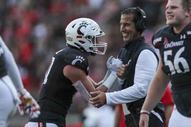 Bearcats tight end Josh Whyle celebrates after a touchdown with head coach Luke Fickell against Murray State on Sept. 11 at Nippert Stadium.