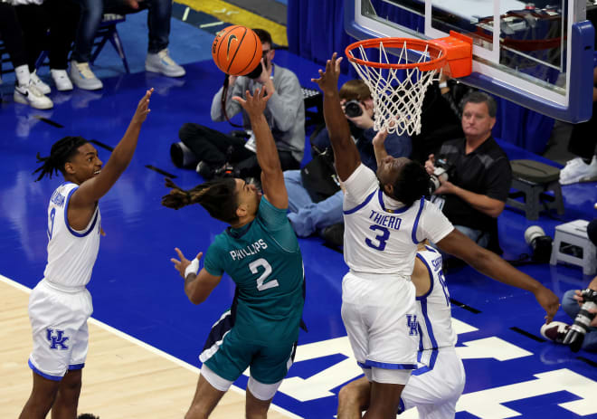 UNC-Wilmington's Shykeim Phillips (2) tried to get a shot over the outstretched arm of Kentucky forward Adou Thiero (3) during Saturday's game at Rupp Arena.