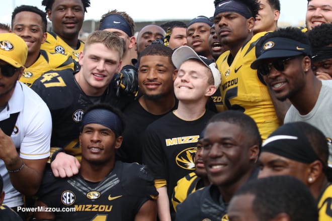 Some of the Tigers pose for pictures with fans