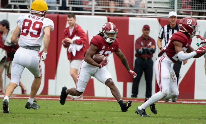 Jahmyr Gibbs (13) makes a cut during Alabama's spring scrimmage.