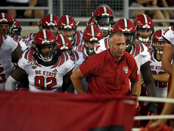 NC State Wolfpack football head coach Dave Doeren leads the team onto the field.