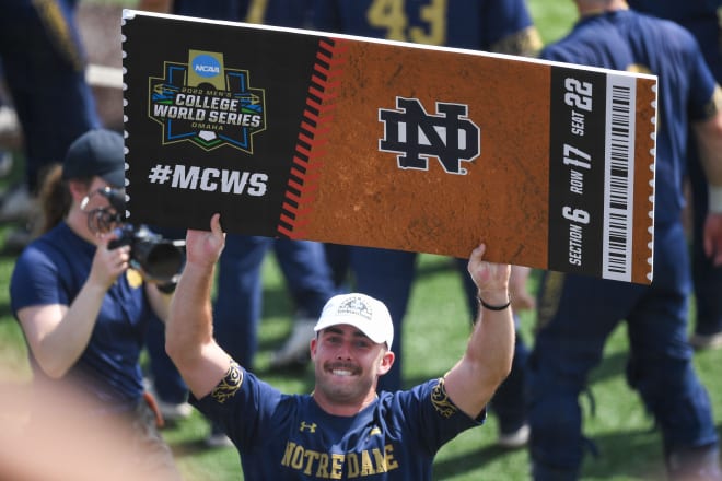 Notre Dame's Jack Zyska (7) holds up a replica ticket to the College World Series as Notre Dame advances Sunday in Knoxville, Tenn.