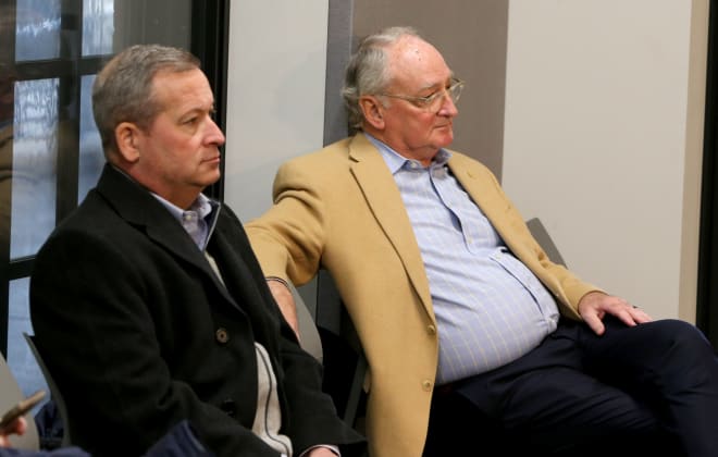 Notre Dame deputy athletic director Jim Fraleigh (left) and athletic director Jack Swarbrick take in coach Mike Brey's press conference on Friday.