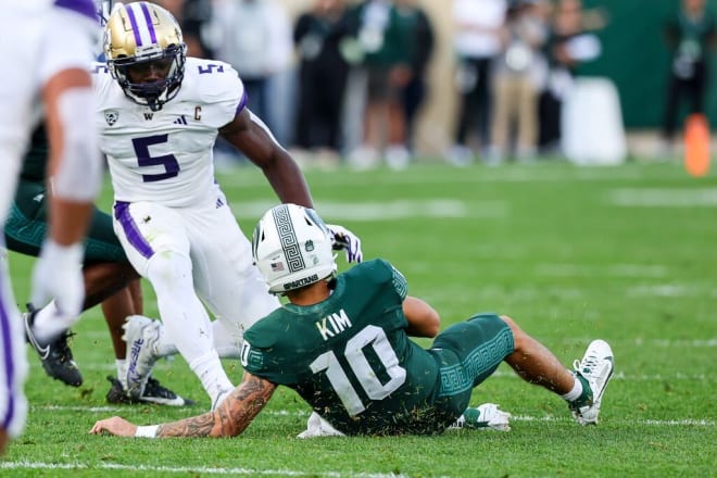 Michigan State's Noah Kim slides shy of the first down to avoid a tackle during the first half against Washington at Spartan Stadium in East Lansing, Mich. on Sept. 16, 2023.