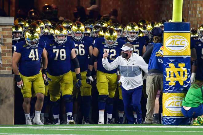 Notre Dame football head coach Brian Kelly lead his team onto the field before a game