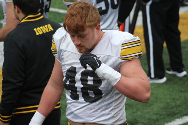 Llewellyn walks the sideline at Iowa's open spring practice. 