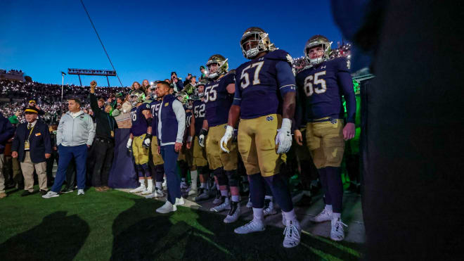 Notre Dame coach Marcus Freeman (center) has already started practices for his team's upcoming bowl game.