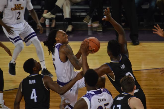 ECU's Kentrell Barkley drives on Tulsa's Junior Etou for two of his 19 points in a 69-66 victory.